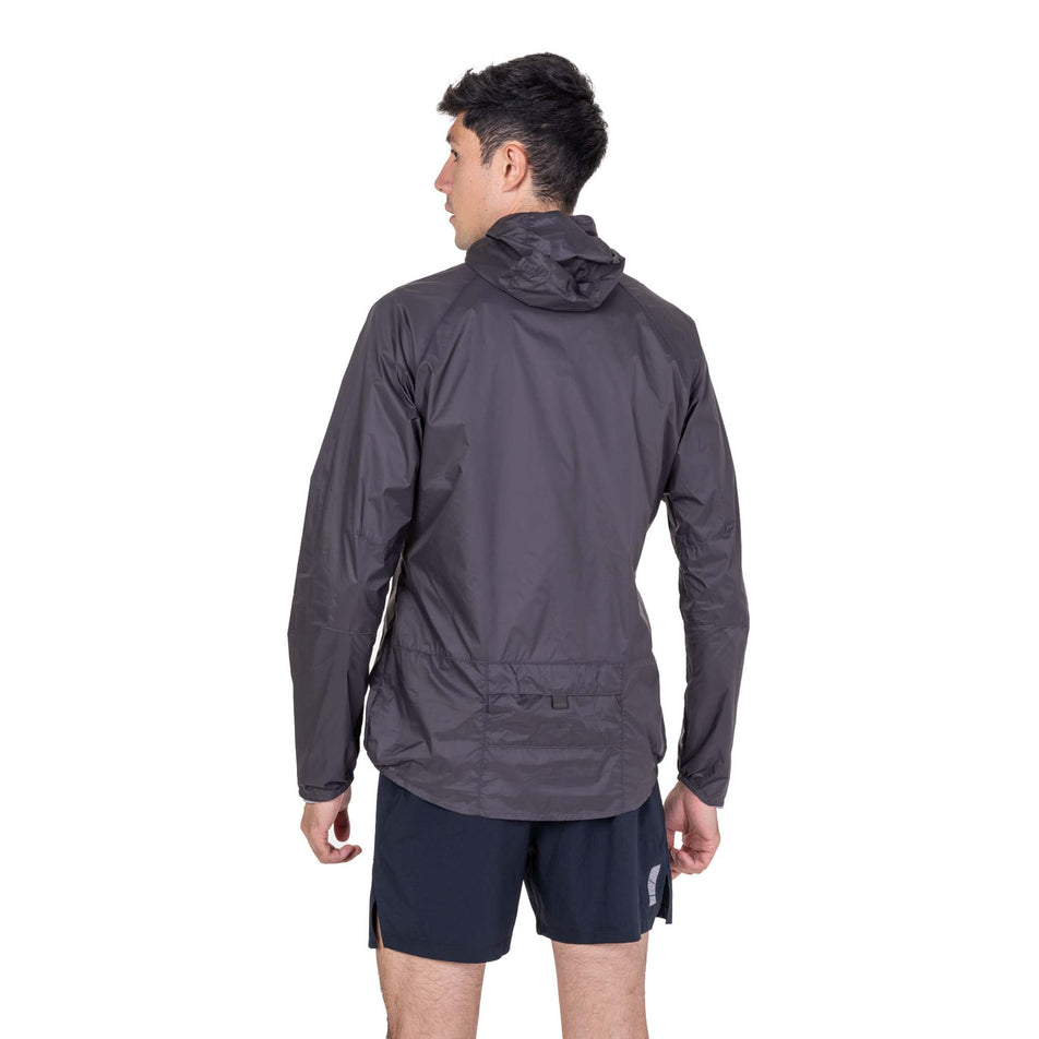 Back view of a model wearing the Ronhill Men's Tech All-Terrain Jacket in the Oxide/Ronhill Red colourway.
