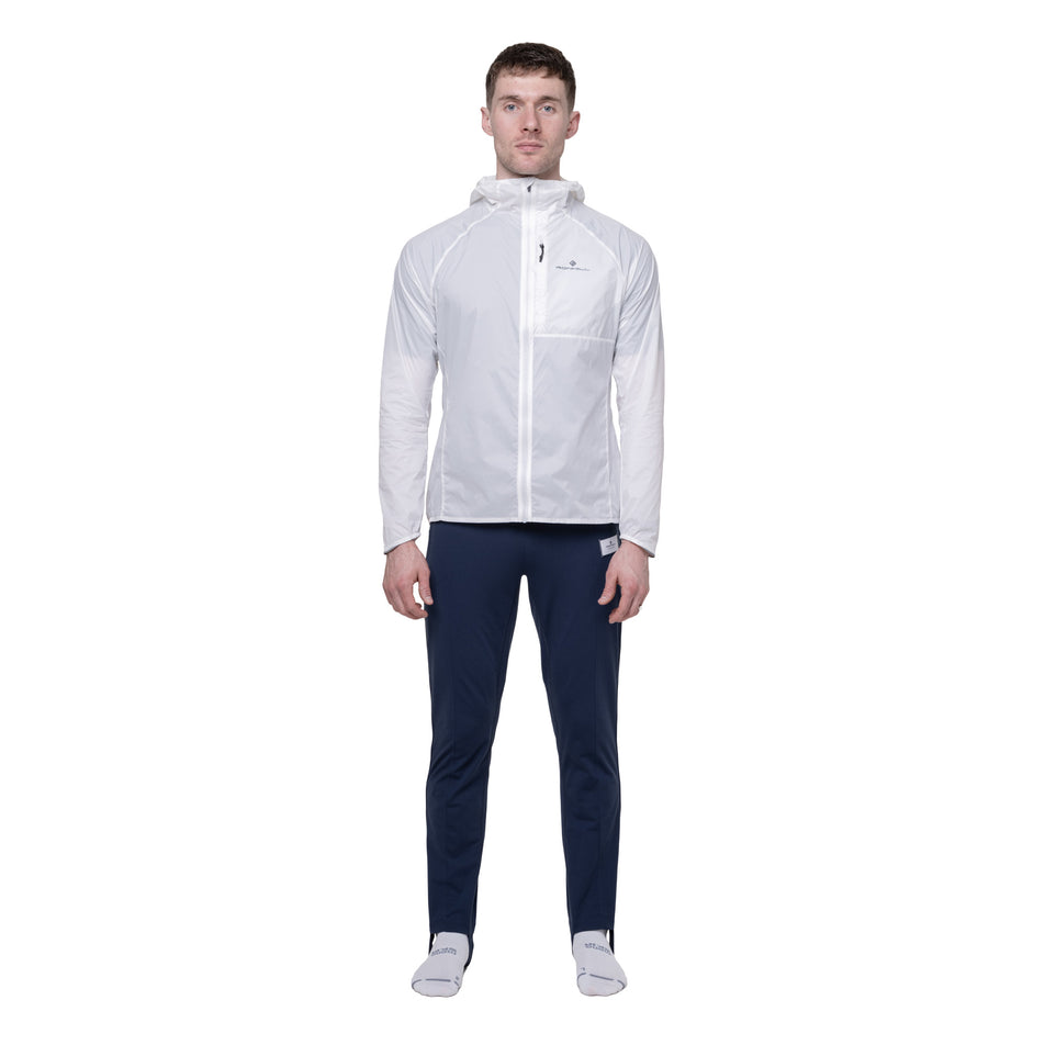Front view of a model wearing the Ronhill Men's Tech All-Terrain Jacket in the Bright White colourway. 
