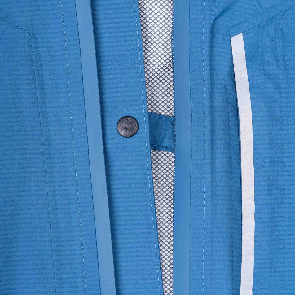 Close-up view of the chest clip on the Ronhill Men's Tech Storm Jacket in the Glacier/Ronhill Red colourway.