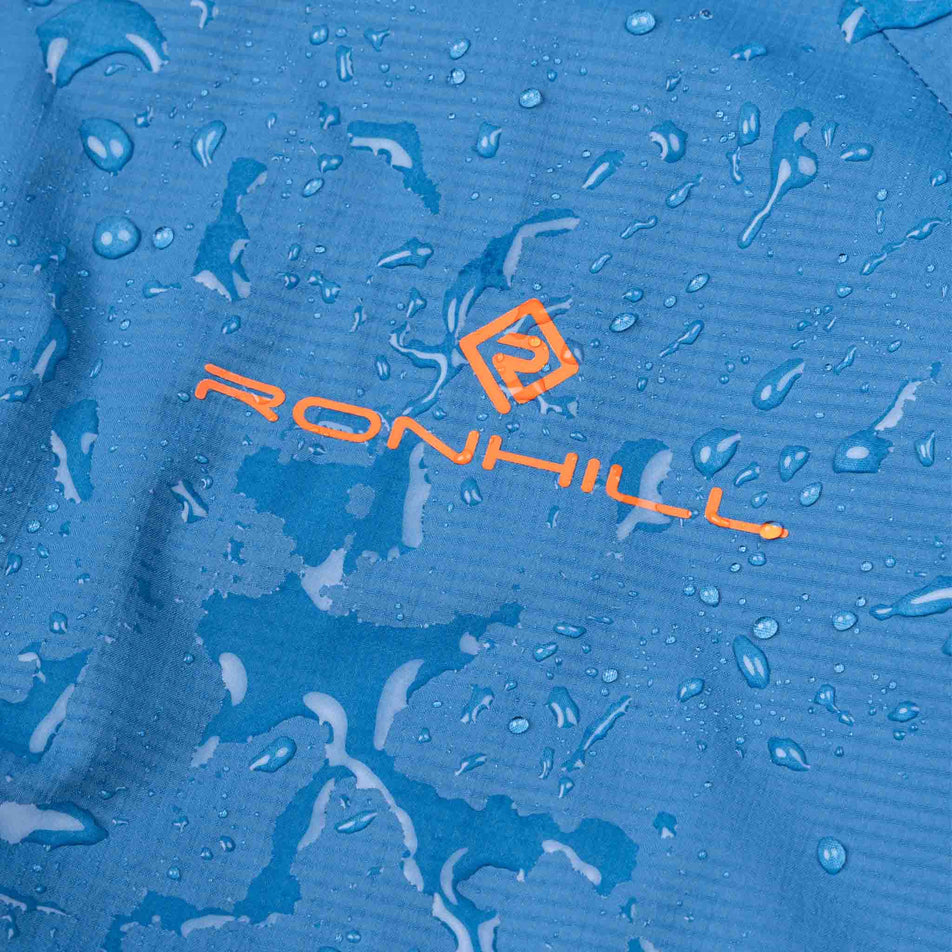 The waterproof fabric of the Ronhill Men's Tech Storm Jacket in the Glacier/Ronhill Red colourway.