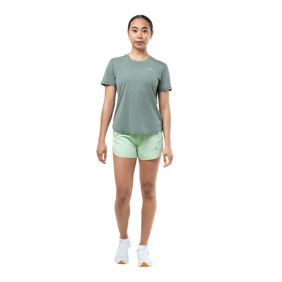 Front view of a model wearing the Ronhill Women's Tech S/S Tee in the Laurel/Seafoam colourway.