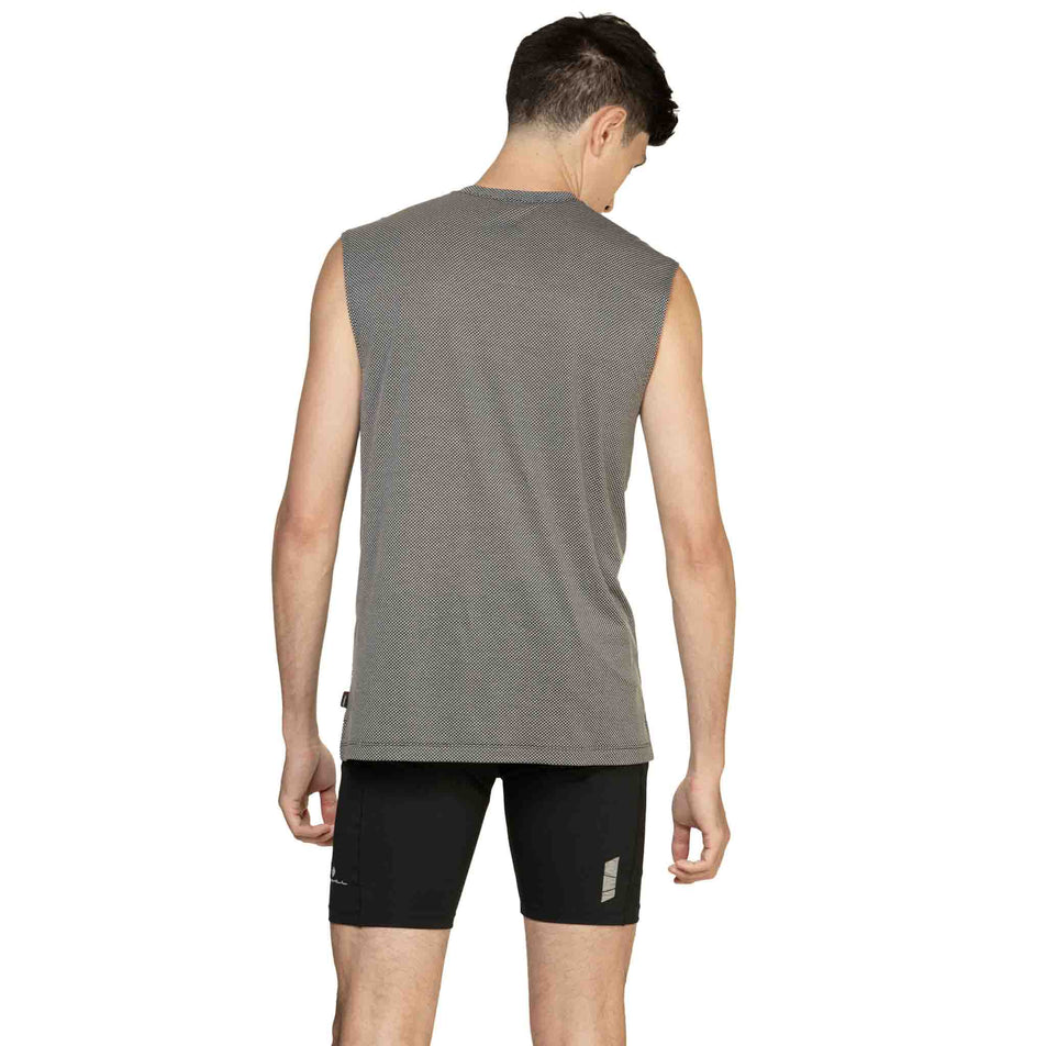Back view of a model wearing the Ronhill Men's Tech Golden Hour Tank in the Black/Matrix colourway. (8565239283874)