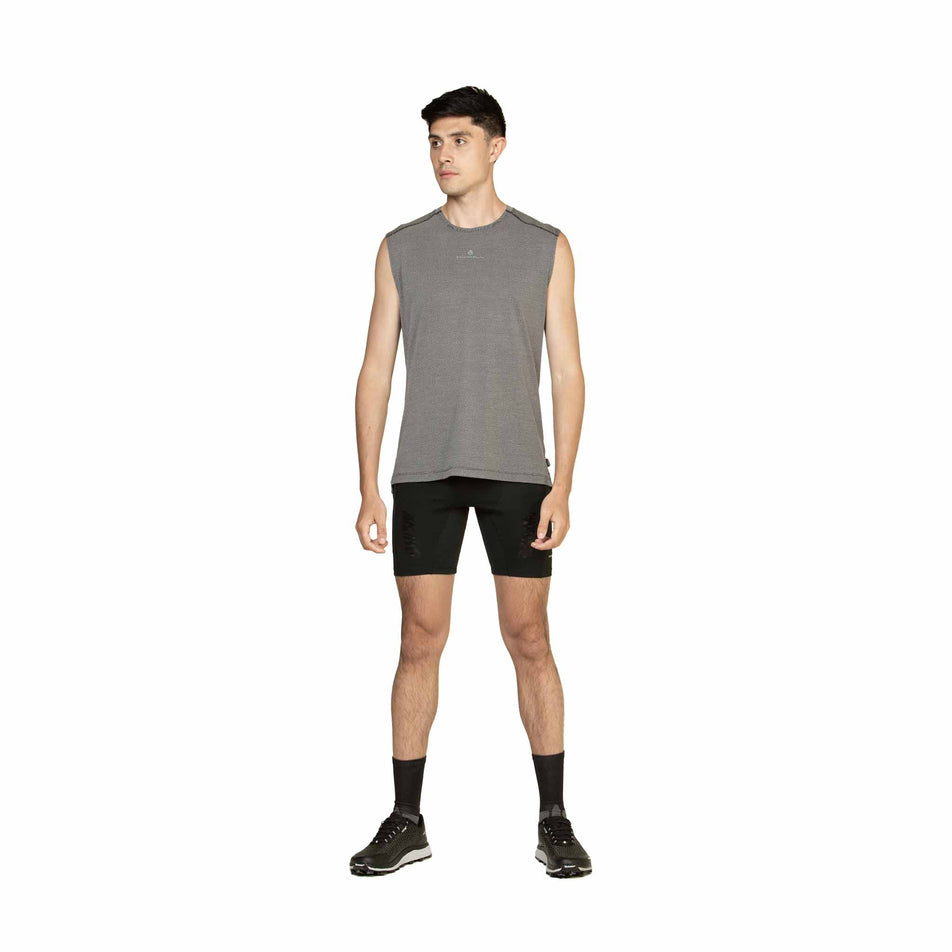 Front view of a model wearing the Ronhill Men's Tech Golden Hour Tank in the Black/Matrix colourway. (8565239283874)