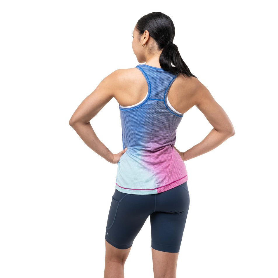 Back view of a model wearing the Ronhill Women's Tech Golden Hour Vest in the Exuberance Merge colourway.