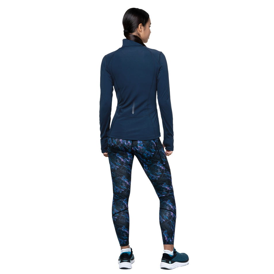 Bacl view of a model wearing the Ronhill Women's Tech Contour Jacket in the Dark Navy colourway. (8742703693986)