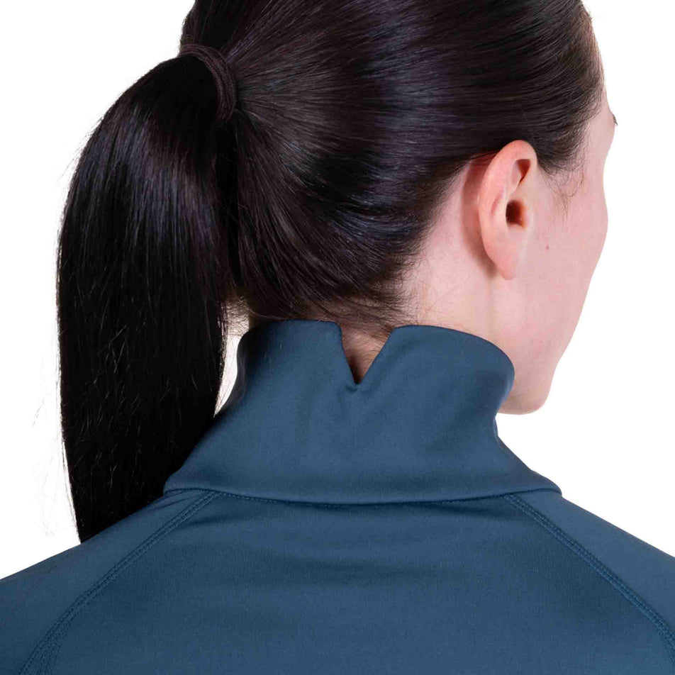 Back view of a model wearing the Ronhill Women's Tech Contour Jacket in the Evening Haze colourway. 