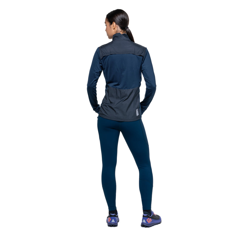 Back view of a model wearing the Ronhill Women's Tech Wind-Block 1/2 Zip in the Dark Navy/Dusty Tulip colourway. (8742677414050)