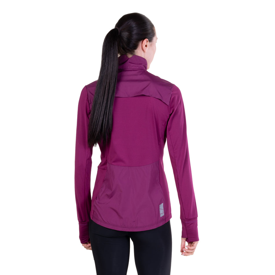 Back view of a model wearing the Ronhill Women's Tech Wind-Block 1/2 Zip in the Blackcurrant colourway.