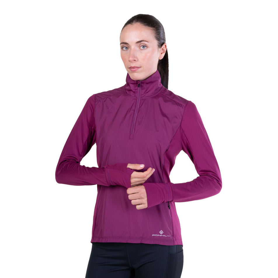 Front view of a model wearing the Ronhill Women's Tech Wind-Block 1/2 Zip in the Blackcurrant colourway.