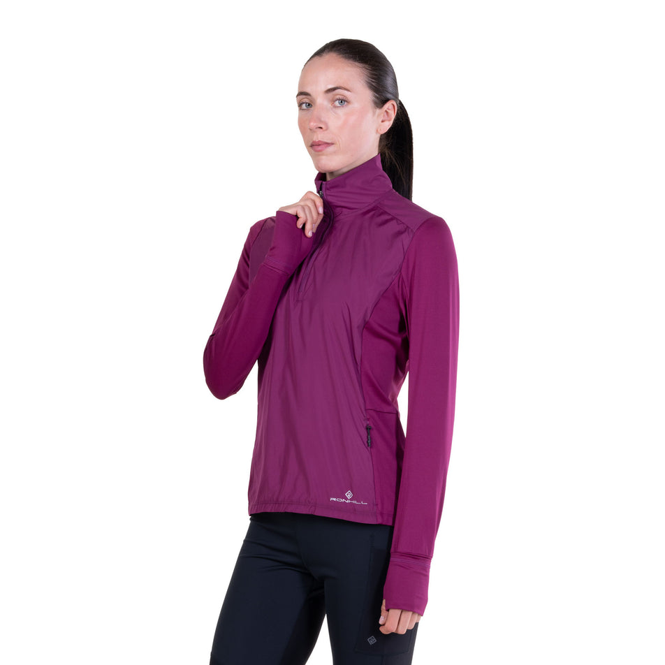 Front view of a model wearing the Ronhill Women's Tech Wind-Block 1/2 Zip in the Blackcurrant colourway.
