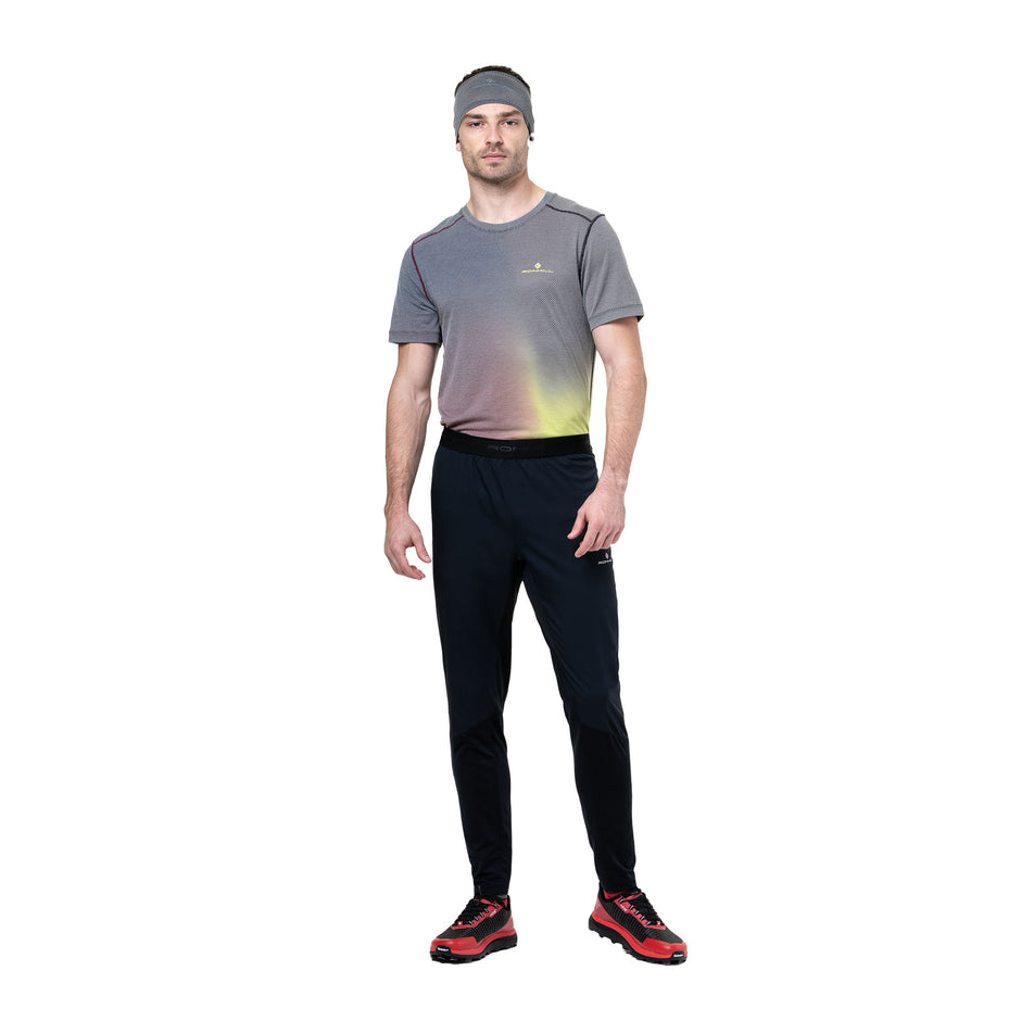 Front view of a model wearing the Ronhill Men's Tech All-Terrain Trackster in the All Black colourway. (8742887096482)