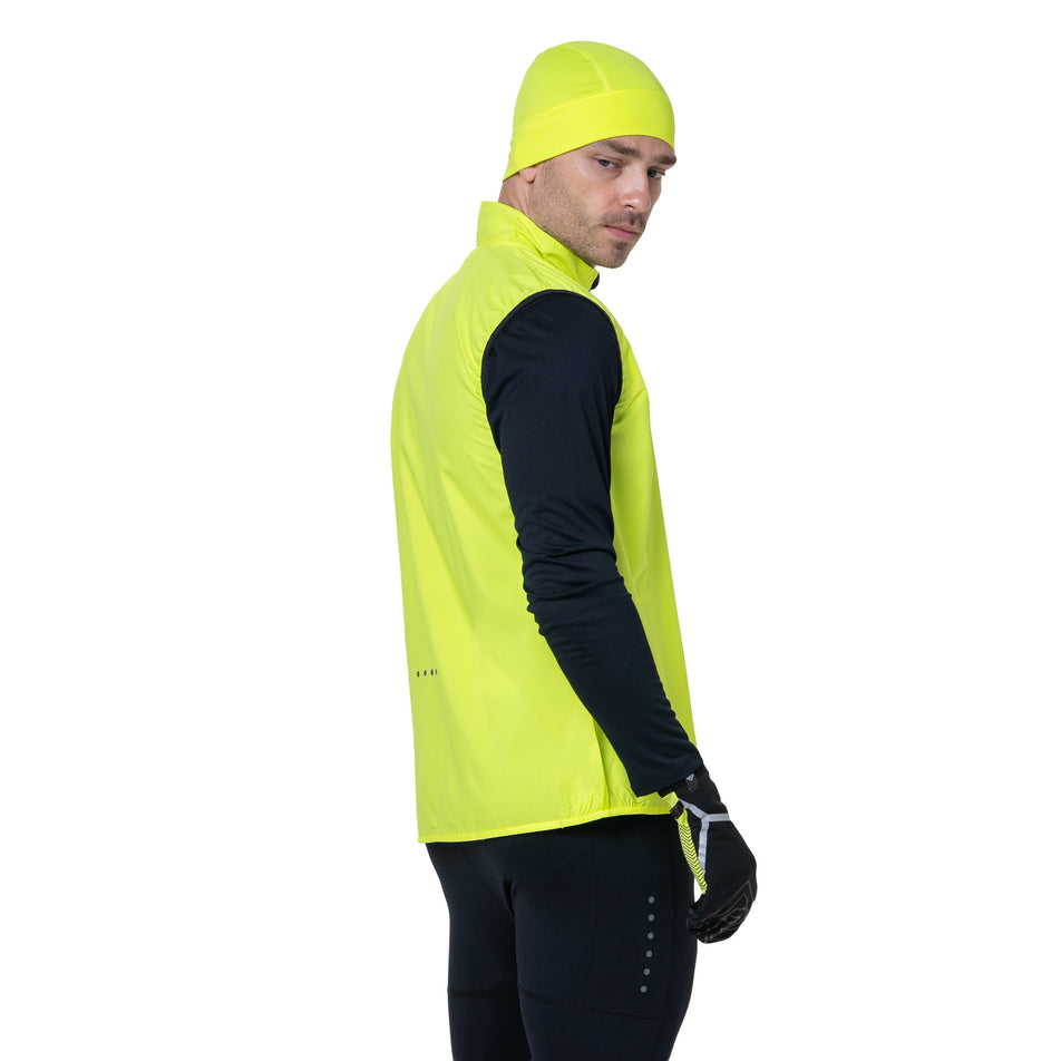 Side view of a model wearing the Ronhill Men's Core Gilet in the Fluo Yellow/Black colourway. (8748546195618)