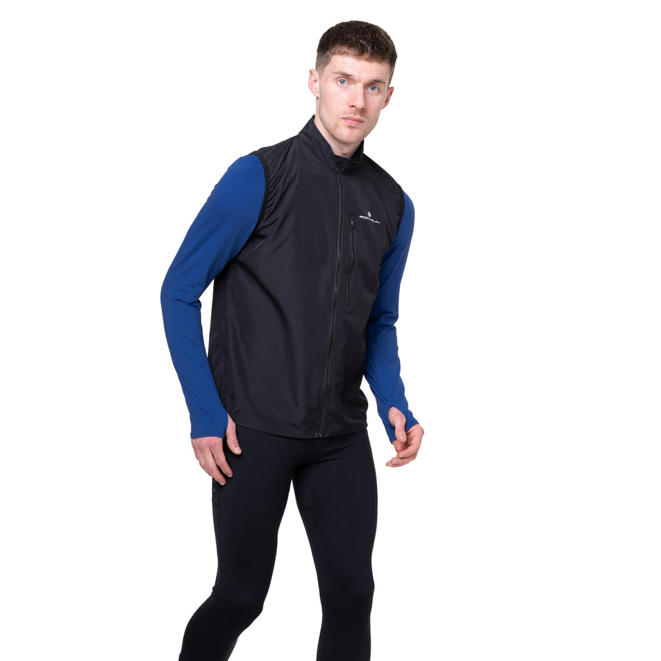 Front view of a model wearing the Ronhill Men's Core Gilet in the Black/Bright White colourway.