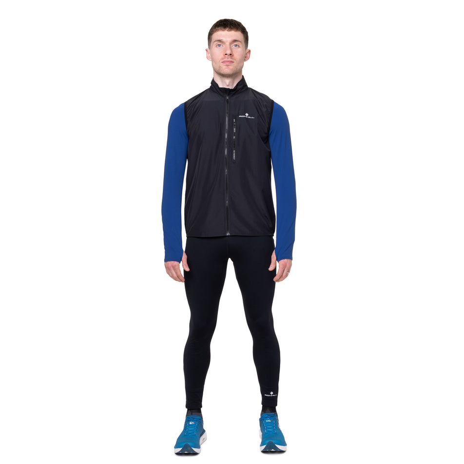 Front view of a model wearing the Ronhill Men's Core Gilet in the Black/Bright White colourway.