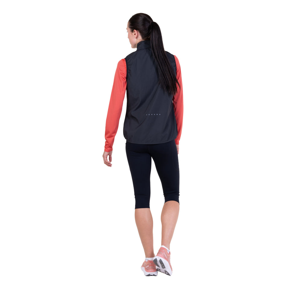 Back view of a model wearing the Ronhill Women's Core Gilet in the Black/Bright White colourway.