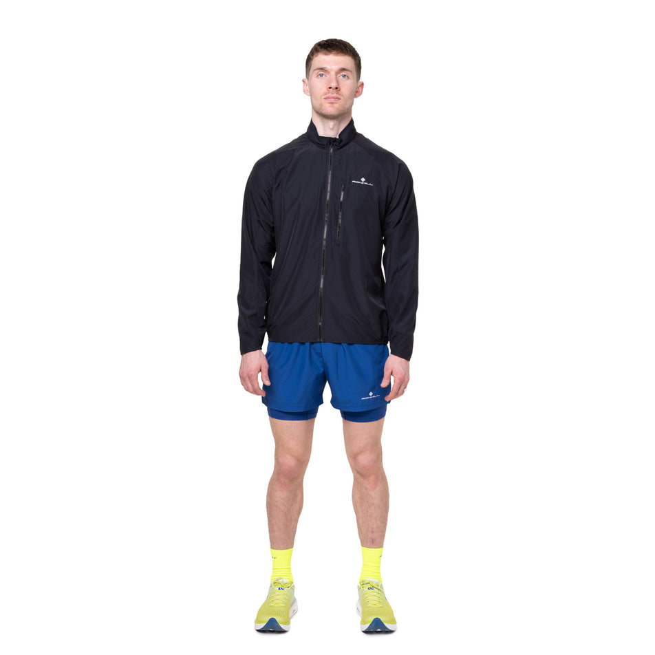 Front view of a model wearing the Ronhill Men's Core Jacket in the Black/Bright White colourway.