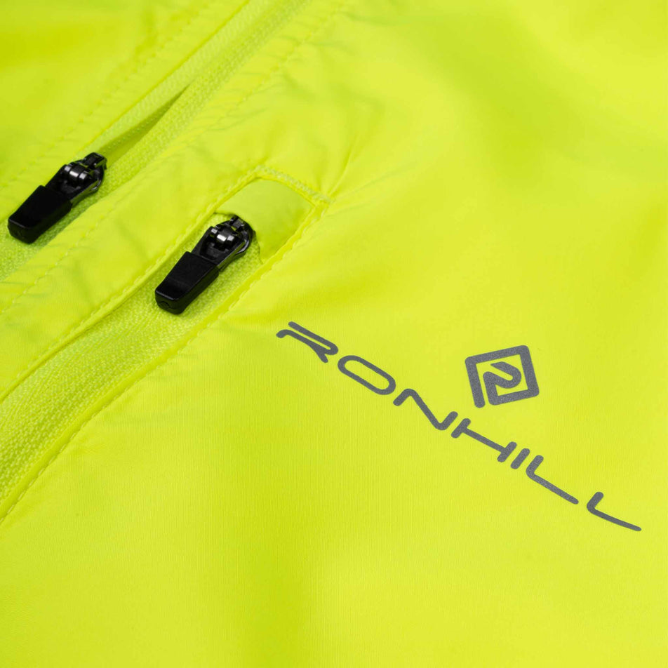 Close-up view of the front of the Ronhill Men's Core Jacket in the Fluo Zest colourway.