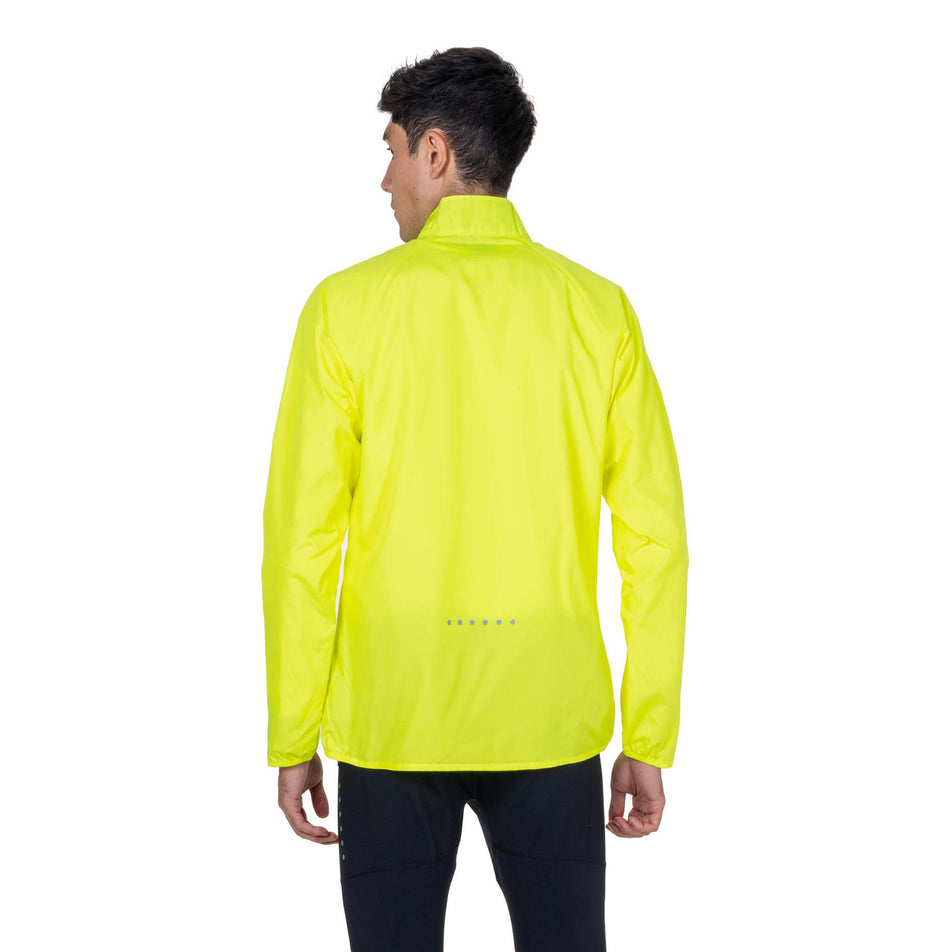 Back view of a model wearing the Ronhill Men's Core Jacket in the Fluo Zest colourway.