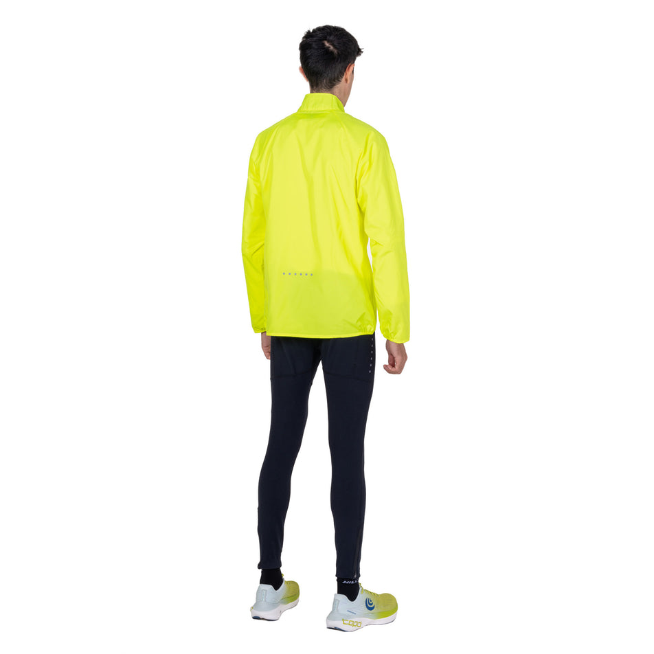 Back view of a model wearing the Ronhill Men's Core Jacket in the Fluo Zest colourway.