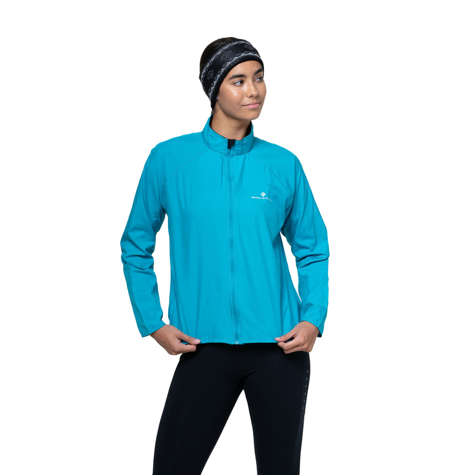 Front view of a model wearing the Ronhill Women's Core Jacket in the Azure/Bright White colourway. (8747610931362)