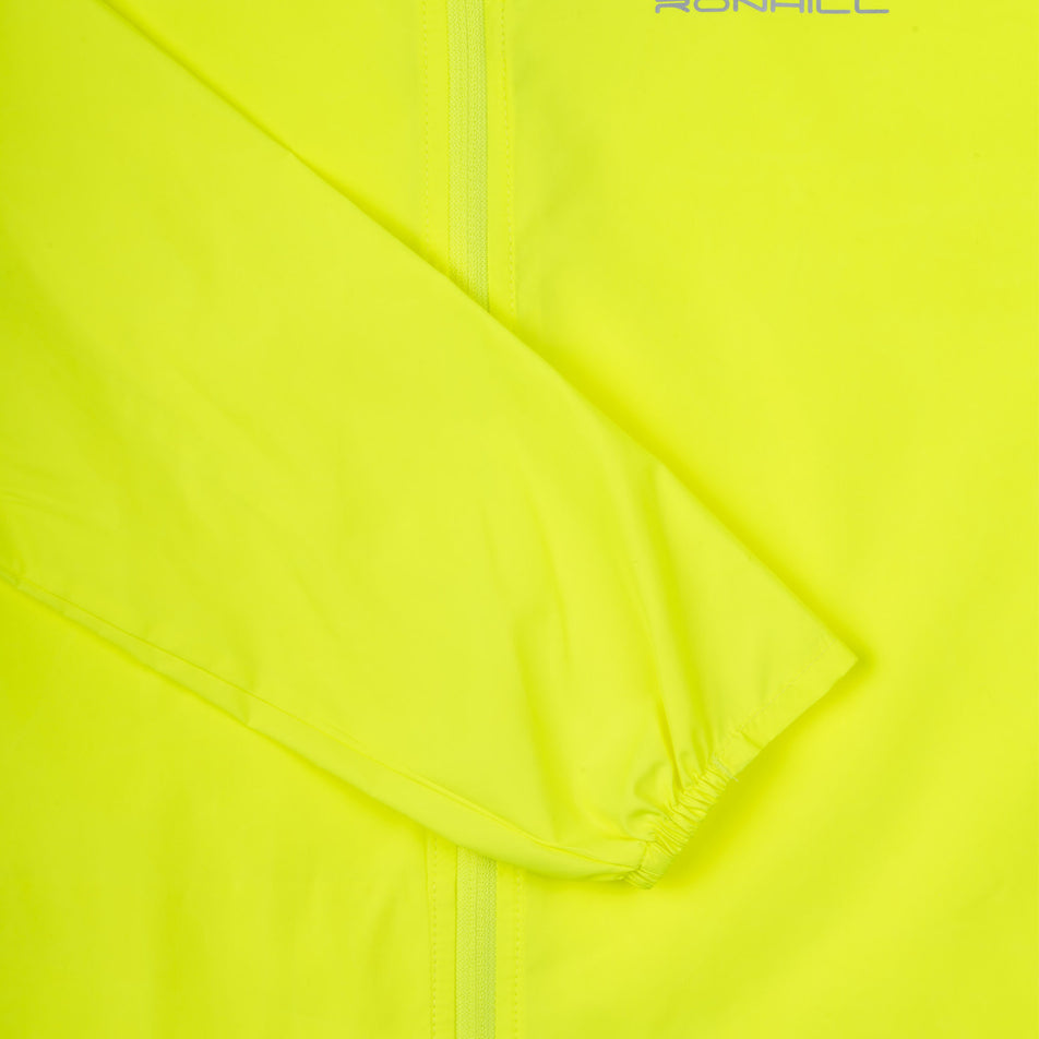 Close-up view of the sleeve of the Ronhill Women's Core Jacket in the Fluo Zest colourway.