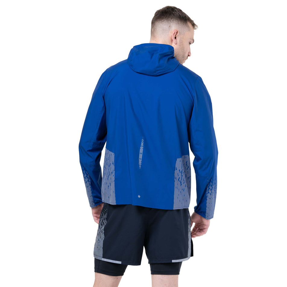 Back view of a model wearing the Ronhill Men's Tech Reflect Jacket in the Ocean/Reflect colourway. (8747618762914)