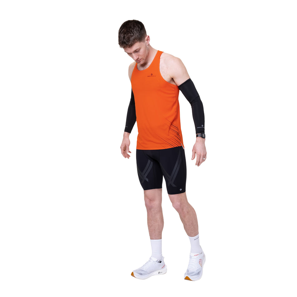 Front view of a model wearing the Ronhill Men's Tech Race Half Tight in the All Black colourway.