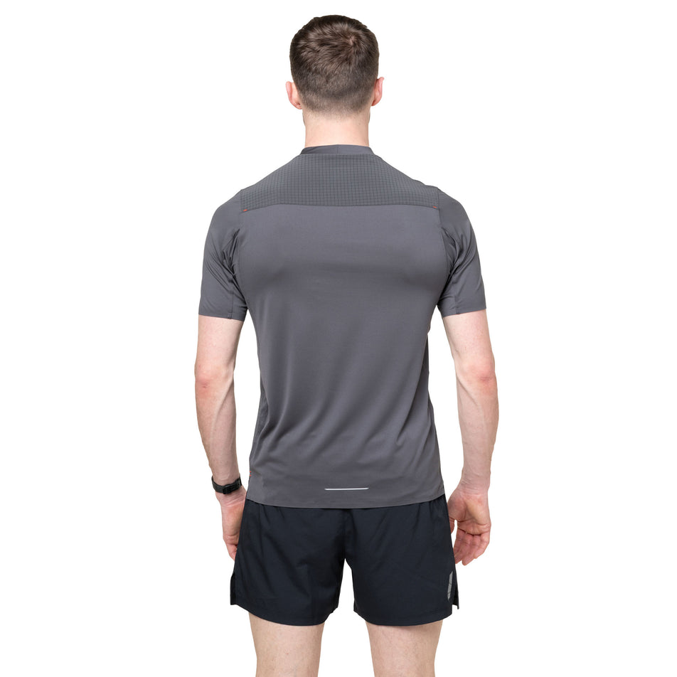 Back view of a model wearing the Ronhill Men's Tech All-Terrain S/S Tee in the Oxide colourway.