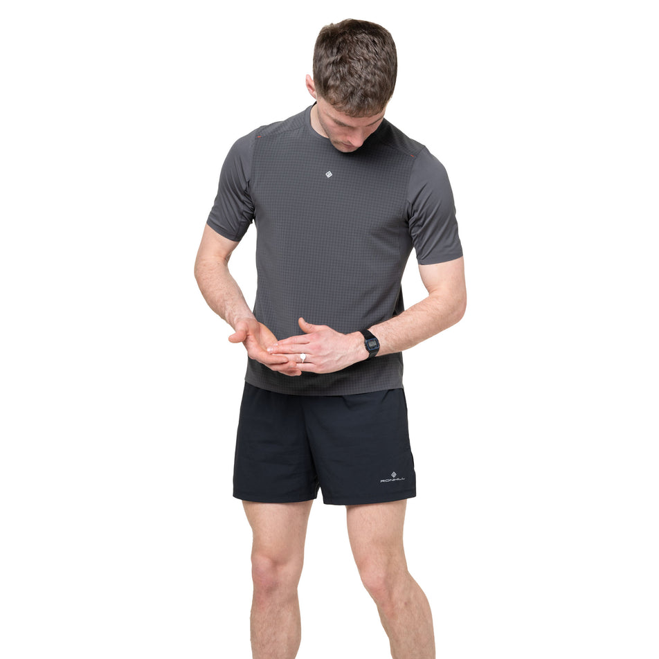 Front view of a model wearing the Ronhill Men's Tech All-Terrain S/S Tee in the Oxide colourway.