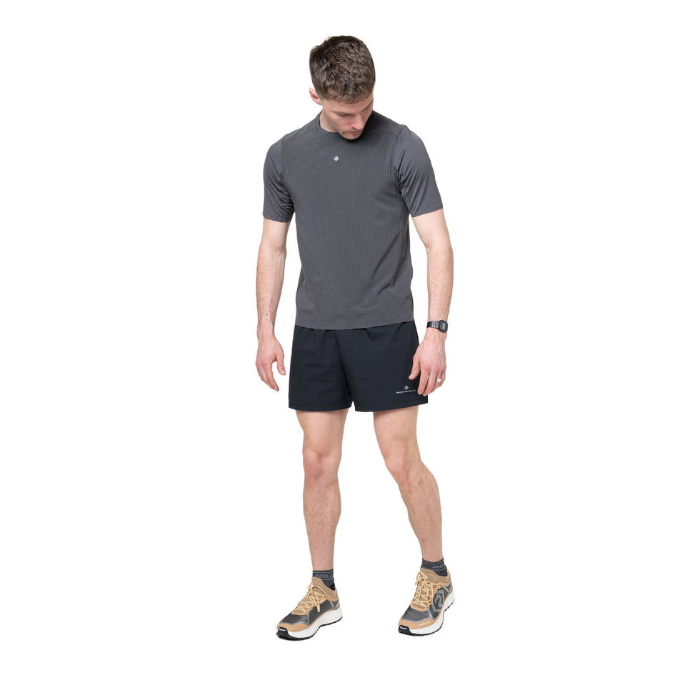 Front view of a model wearing the Ronhill Men's Tech All-Terrain S/S Tee in the Oxide colourway.