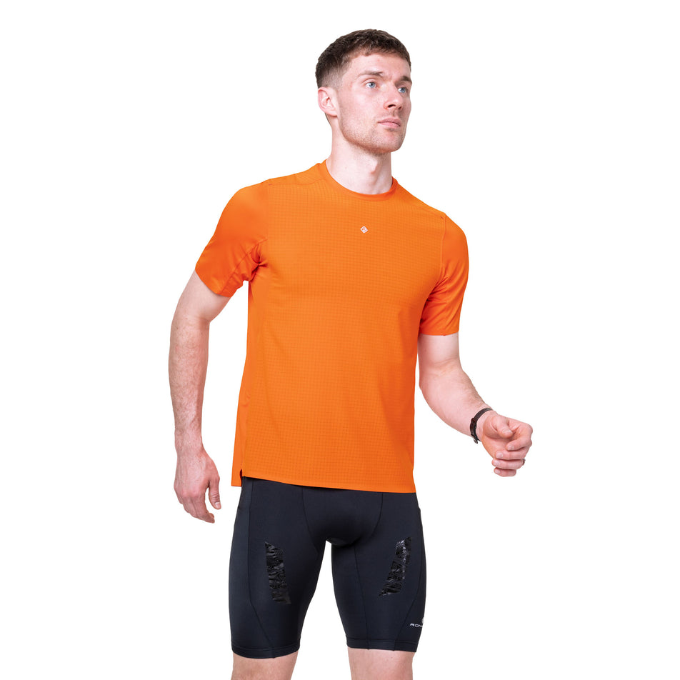 Front view of a model wearing the Ronhill Men's Tech All-Terrain S/S Tee in the Ronhill Red colourway.