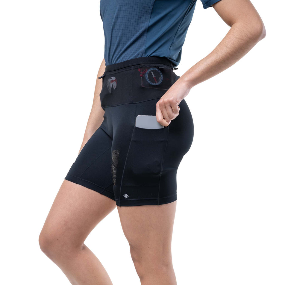 A model demonstrating the stash pocket on the side of the Ronhill Women's Tech All-Terrain 7