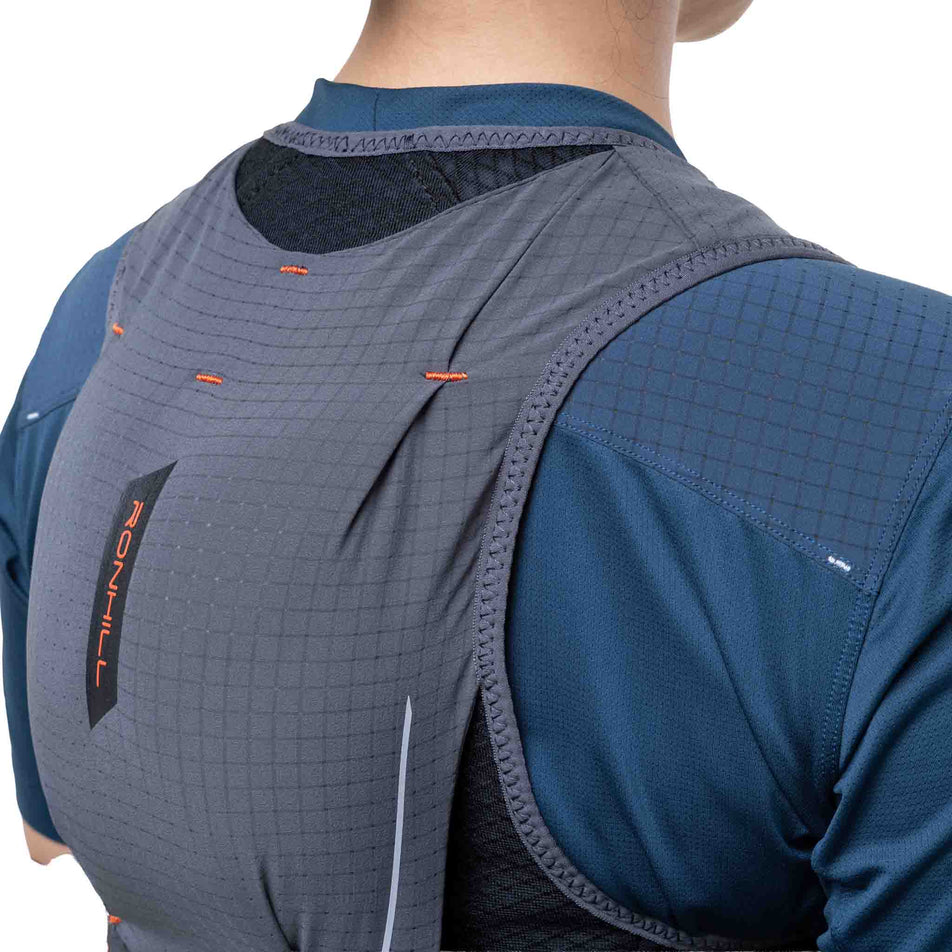 Back view of a model wearing the Ronhill Unisex Solus 5L in the Black/Ronhill Red colourway.