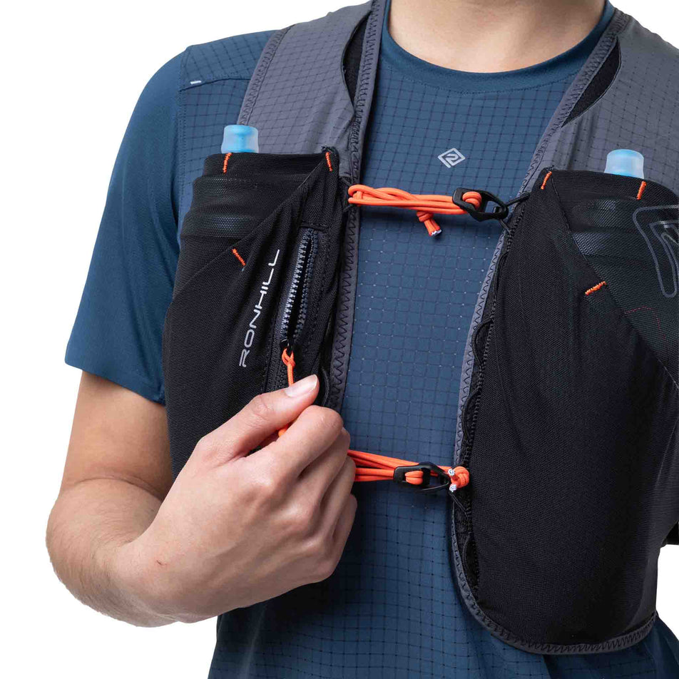 Front view of a model wearing the Ronhill Unisex Solus 5L in the Black/Ronhill Red colourway.