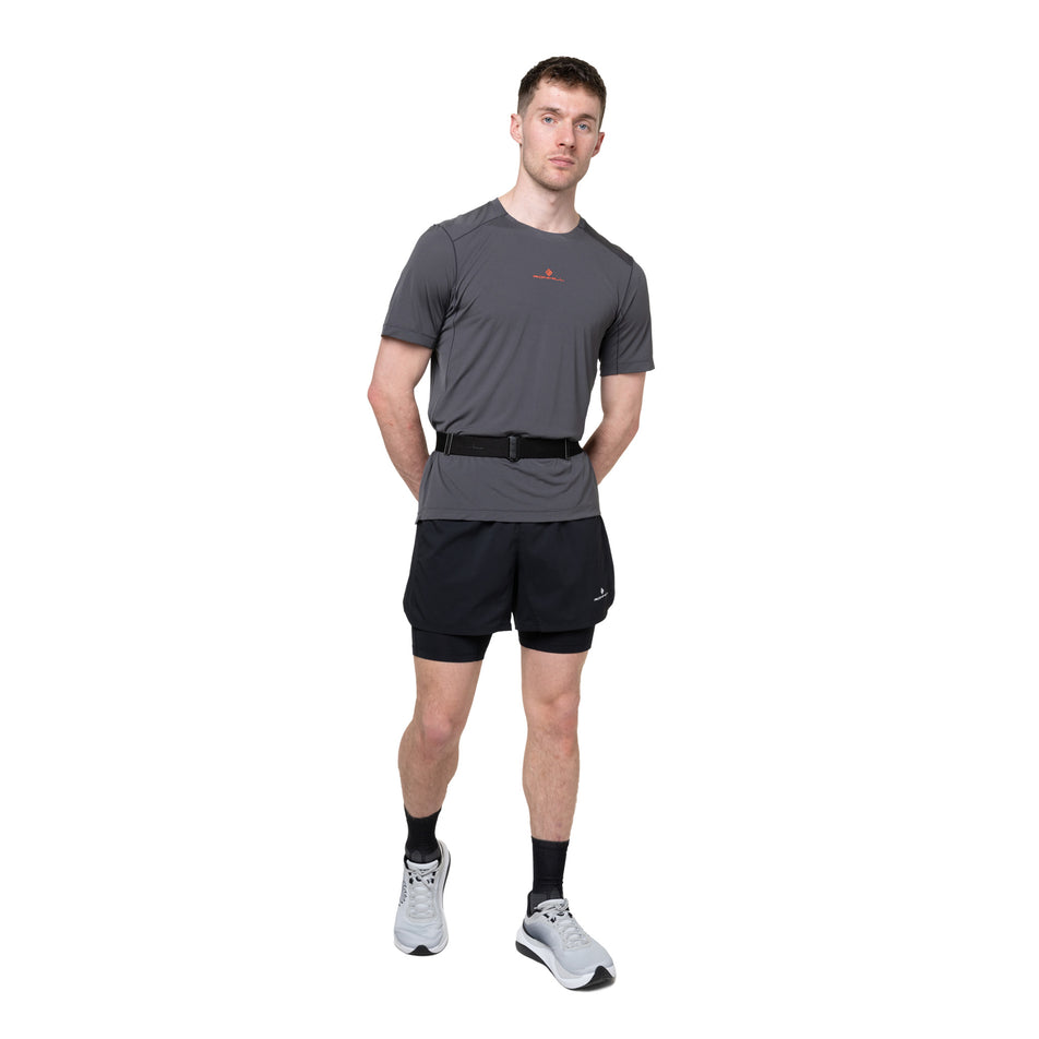Front view of a model wearing the Ronhill Unisex Speed 90 in the Black/Ronhill Red colourway.