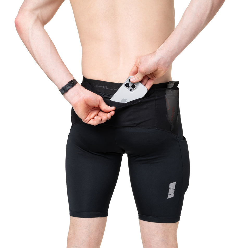 A model demonstrating the zip pocket on the back of the Ronhill Men's Tech All-Terrain 10