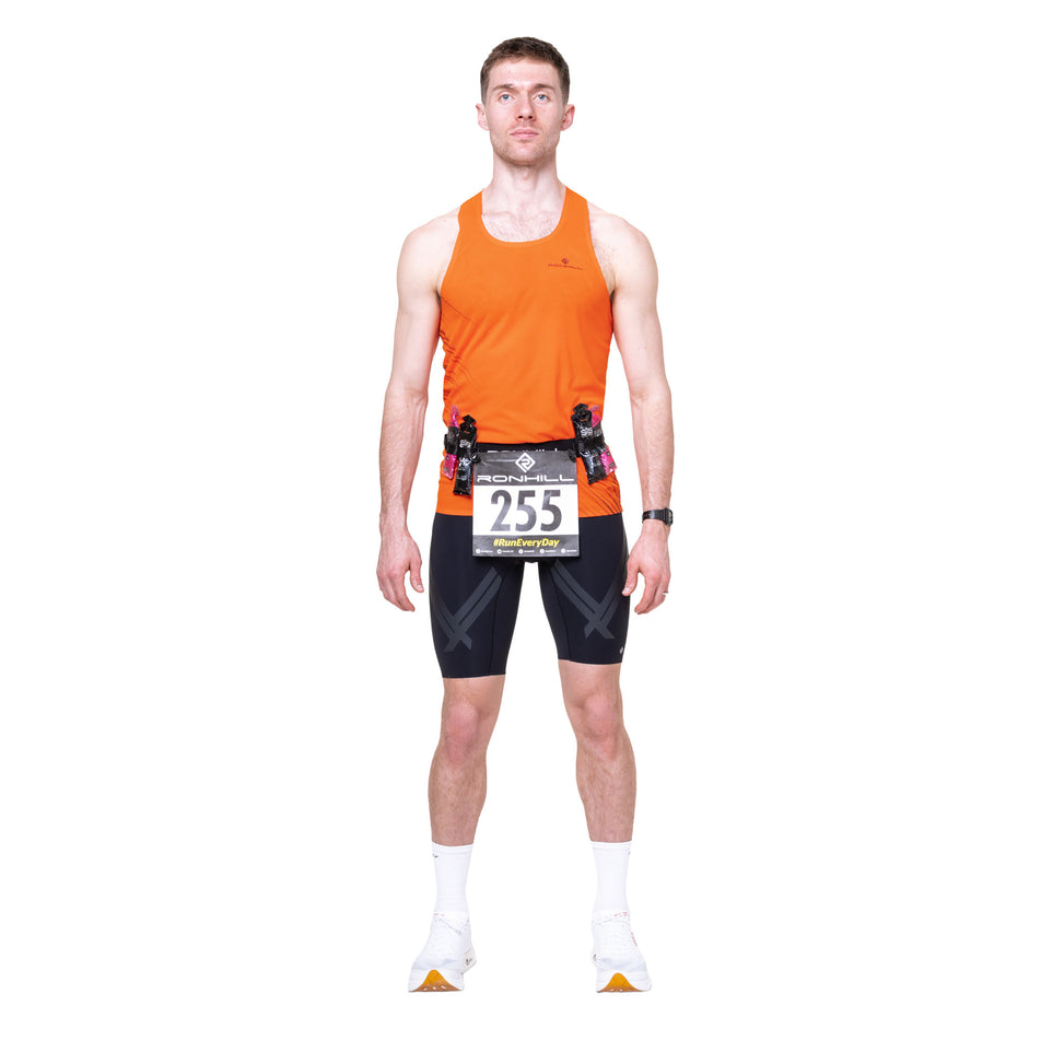 Front view of a model wearing the Ronhill Race Number Belt in the All Black colourway.