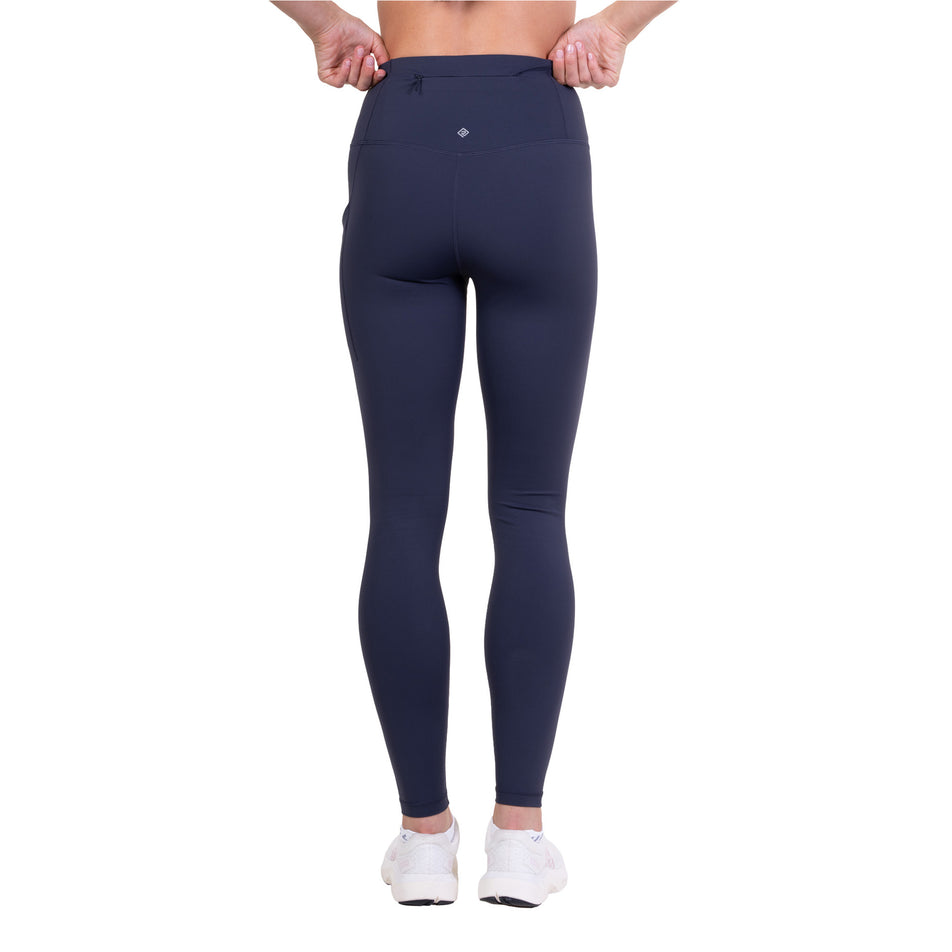 Back view of a model wearing the Ronhill Women's Tech Contour Tight in the Polar Night colourway.