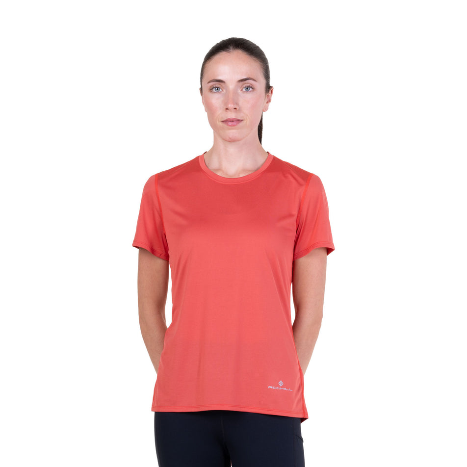 Front view of a model wearing the Ronhill Women's Core S/S Tee in the Sumac colourway.