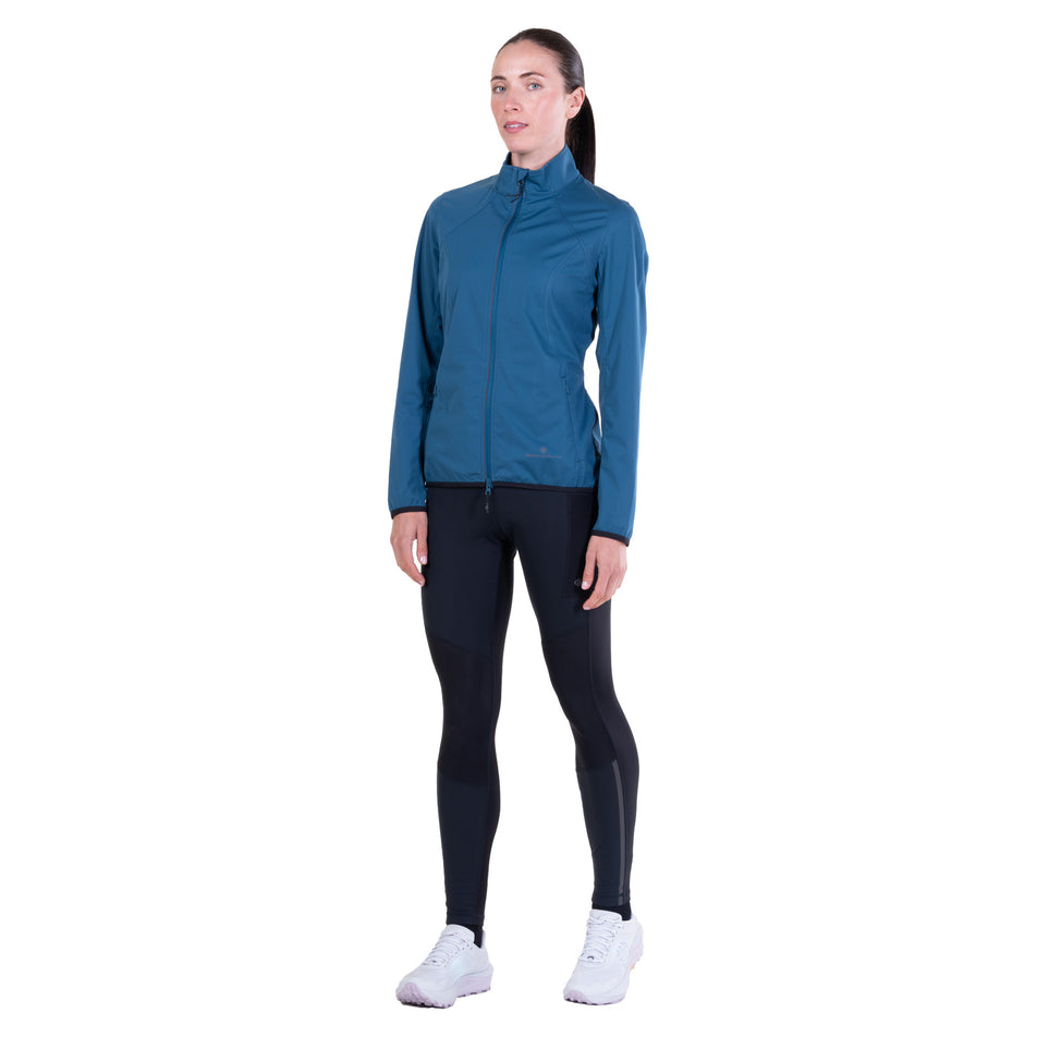 Front view of a model wearing the Ronhill Women's Tech Wind-Block Jacket in the Legion Blue colourway.