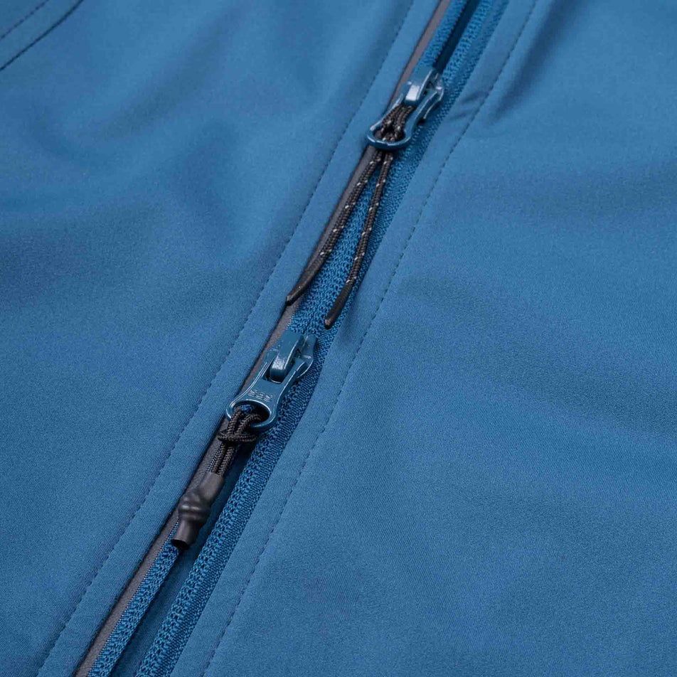 The two-way zipper on the Ronhill Women's Tech Wind-Block Jacket in the Legion Blue colourway.
