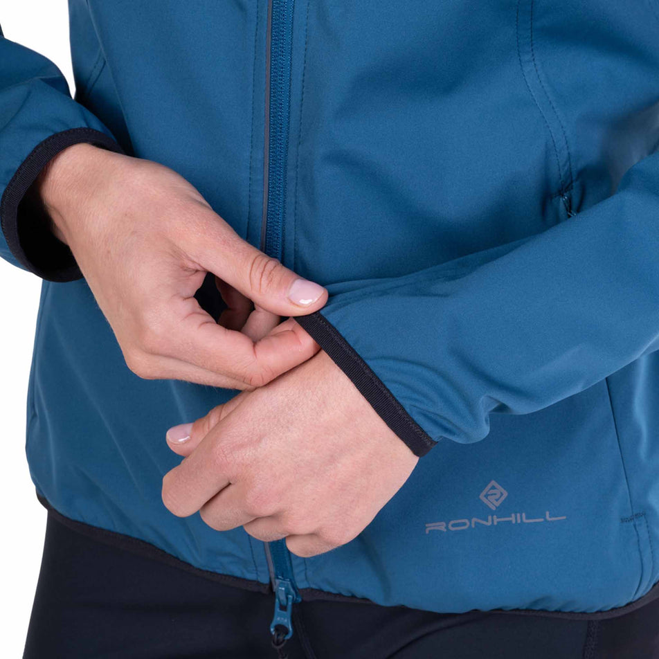The sleeve of the Ronhill Women's Tech Wind-Block Jacket in the Legion Blue colourway.