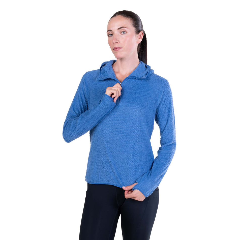 Front view of a model wearing the Ronhill Women's Tech Winter Primaloft Hoodie in the Lumiere/Sumac colourway.