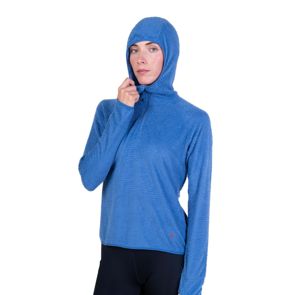 Front view of a model wearing the Ronhill Women's Tech Winter Primaloft Hoodie in the Lumiere/Sumac colourway.