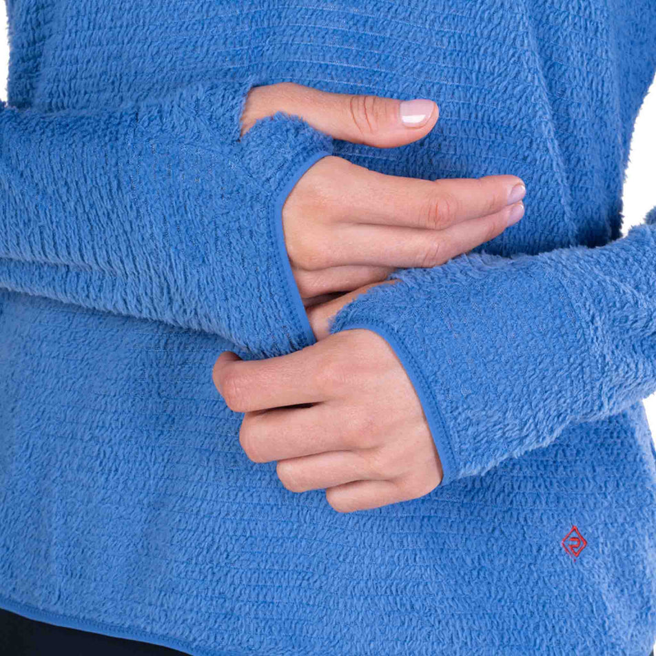 A model demonstrating the thumbloops on the Ronhill Women's Tech Winter Primaloft Hoodie in the Lumiere/Sumac colourway.