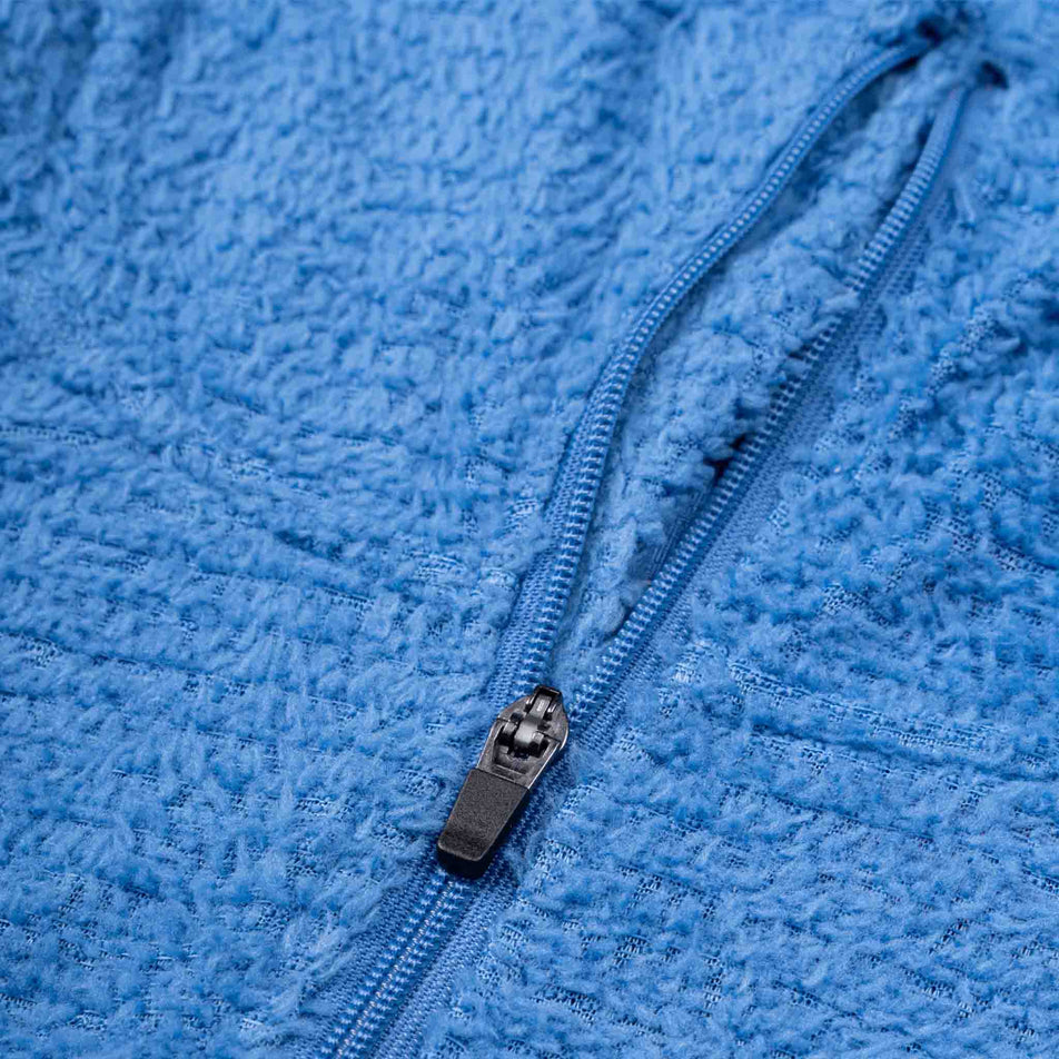 The front zip on the Ronhill Women's Tech Winter Primaloft Hoodie in the Lumiere/Sumac colourway.