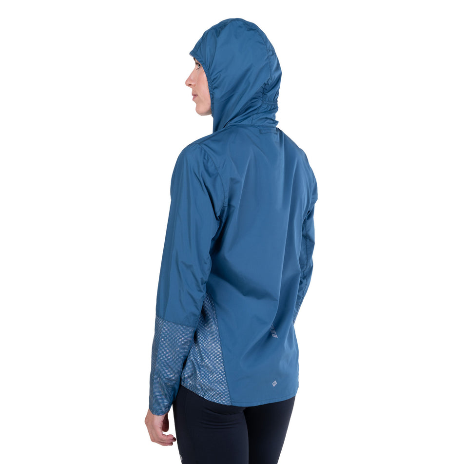 Back view of a model wearing the Ronhill Women's Tech Reflect Jacket in the Legion Blue/Reflect colourway.