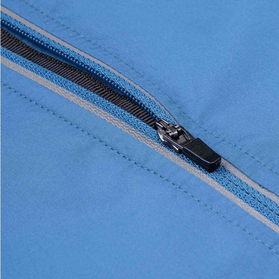 Close-up view of the front zip of the Ronhill Men's Tech Reflect Jacket in the Glacier/Reflect colourway.