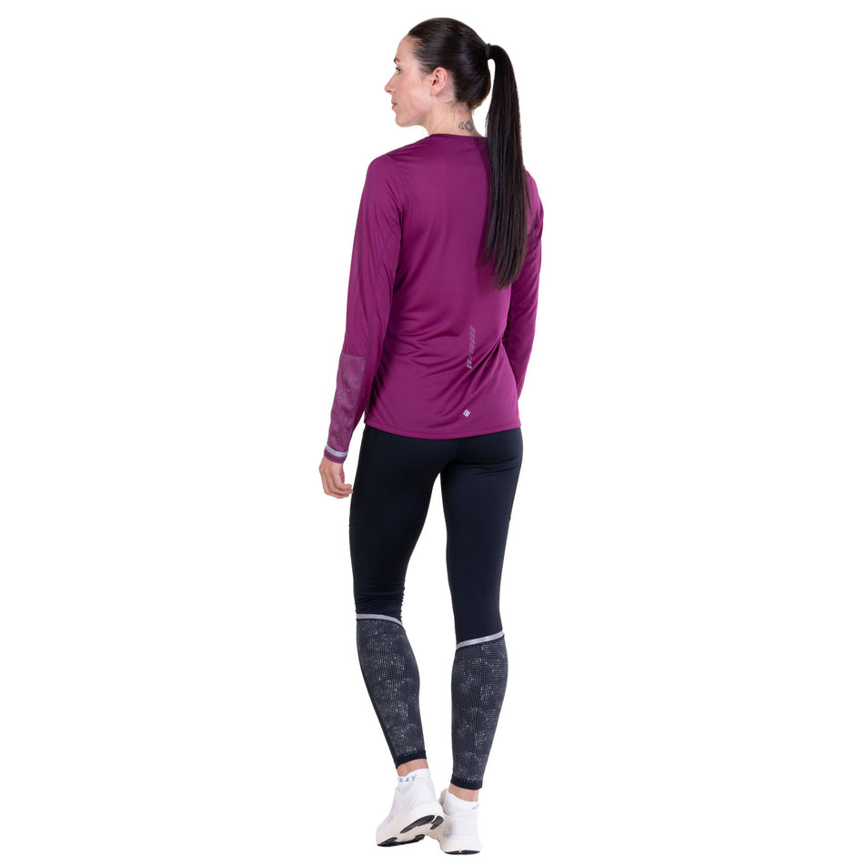 Back view of a model wearing the Ronhill Women's Tech Reflect L/S Tee in the Blackcurrant/Reflect colourway.