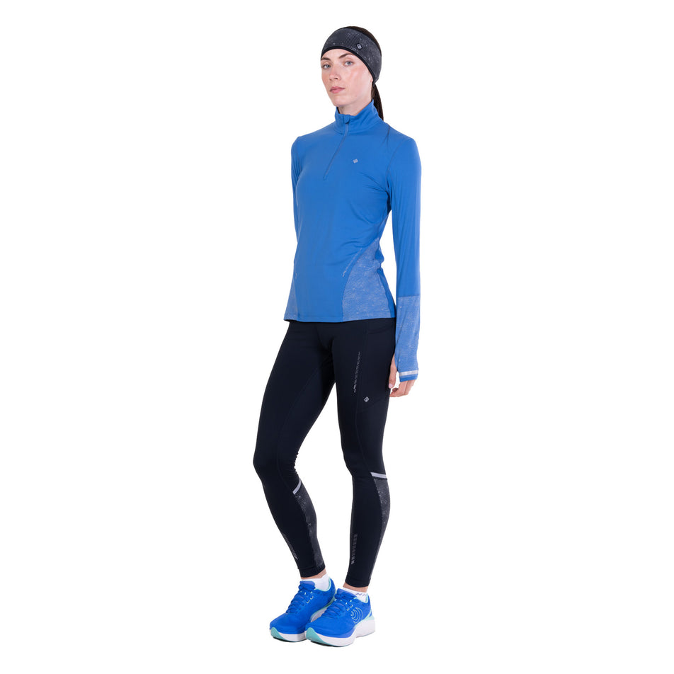 Front view of a model wearing the Ronhill Women's Tech Reflect 1/2 Zip in the Lumiere/Reflect colourway.